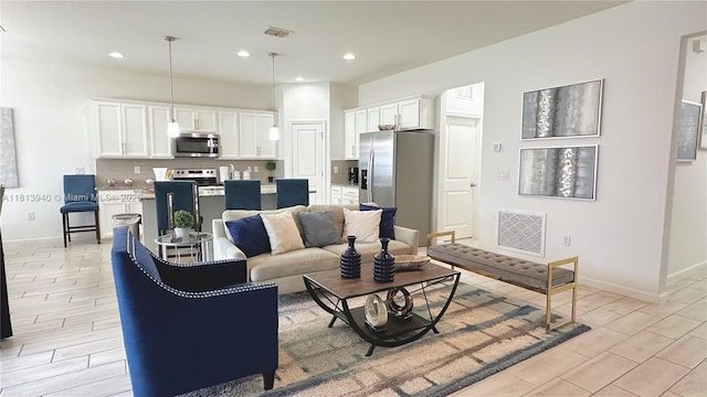 486 Disa Dr, Davenport, FL 33837 - living room featuring baseboards, recessed lighting, and wood tiled floors
