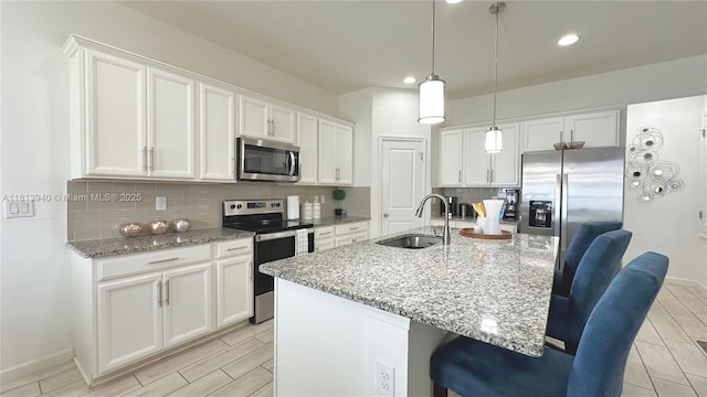 486 Disa Dr, Davenport, FL 33837 - kitchen featuring stainless steel appliances, a sink, tasteful backsplash, white cabinets, and recessed lighting
