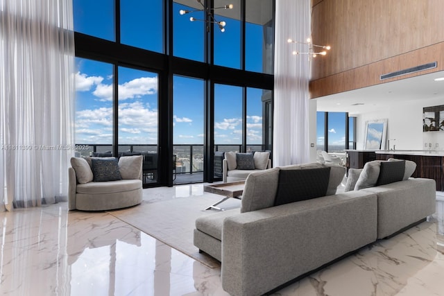 18555 Collins Ave Unit 4603, Sunny Isles Beach, FL 33160 - living room featuring a high ceiling, marble tiled floors, and a chandelier