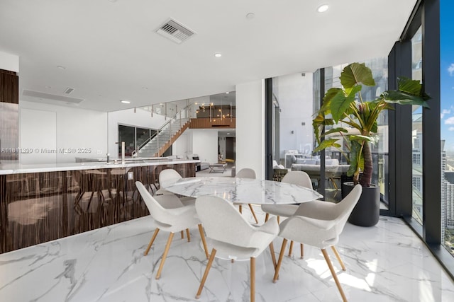 18555 Collins Ave Unit 4603, Sunny Isles Beach, FL 33160 - dining room featuring light marble finish flooring, stairway, a wall of windows, and recessed lighting