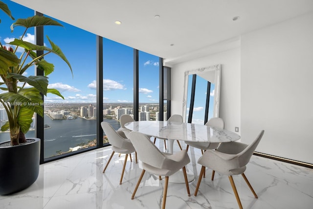 18555 Collins Ave Unit 4603, Sunny Isles Beach, FL 33160 - dining area featuring a wall of windows, a water view, marble tiled floors, recessed lighting, and a city view