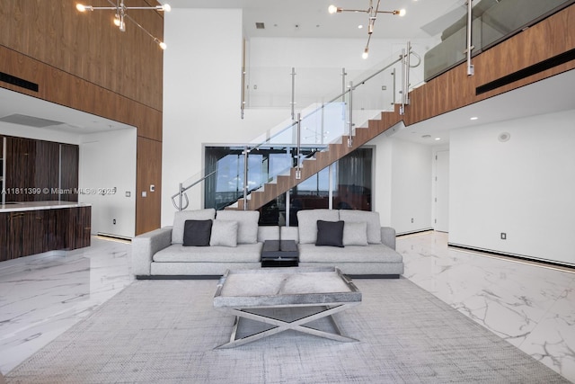 18555 Collins Ave Unit 4603, Sunny Isles Beach, FL 33160 - living room with a high ceiling, light marble finish flooring, stairs, and a chandelier