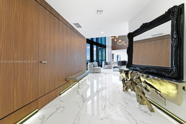 18555 Collins Ave Unit 4603, Sunny Isles Beach, FL 33160 - hall featuring marble tiled floors and a wall of windows