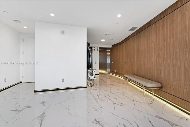18555 Collins Ave Unit 4603, Sunny Isles Beach, FL 33160 - empty room with recessed lighting, wood walls, and light marble finish flooring