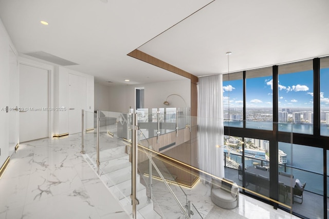 18555 Collins Ave Unit 4603, Sunny Isles Beach, FL 33160 - unfurnished room with expansive windows, a water view, recessed lighting, and marble tiled flooring