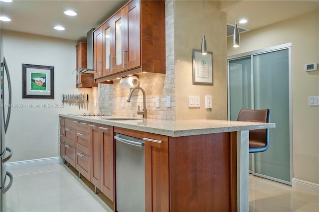 300 Bayview Dr Unit 102, Sunny Isles Beach, FL 33160 - kitchen with dishwasher, a sink, decorative backsplash, light tile patterned floors, and baseboards