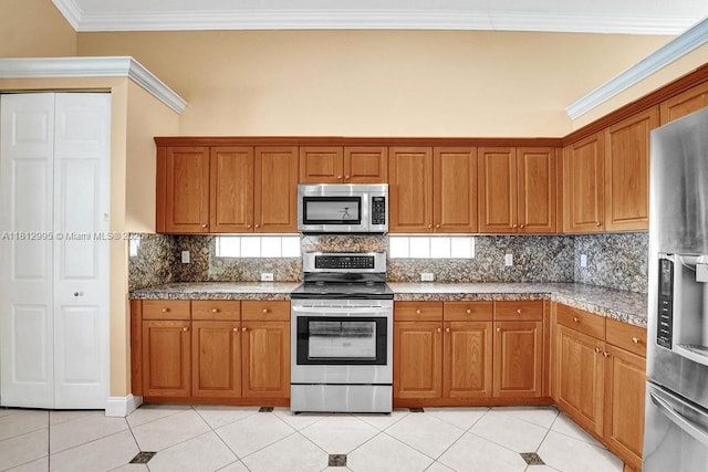 2434 SW 157th Ave, Miramar, FL 33027 - kitchen featuring stainless steel appliances, brown cabinetry, and crown molding