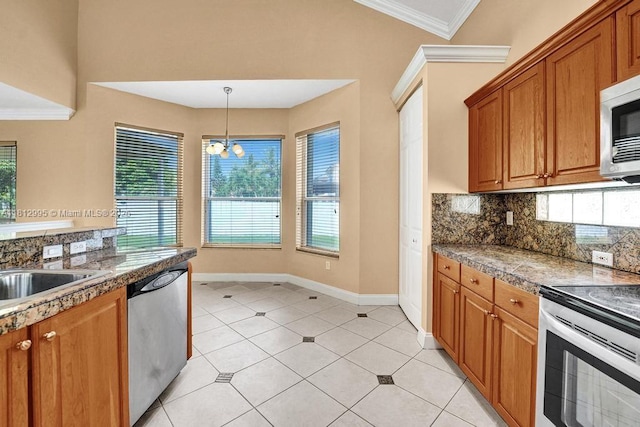2434 SW 157th Ave, Miramar, FL 33027 - kitchen with appliances with stainless steel finishes, crown molding, backsplash, brown cabinets, and tile counters
