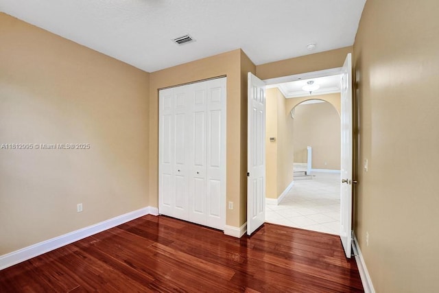 2434 SW 157th Ave, Miramar, FL 33027 - unfurnished bedroom with arched walkways, wood finished floors, a closet, and baseboards