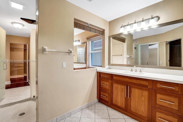 2434 SW 157th Ave, Miramar, FL 33027 - full bathroom featuring tile patterned flooring, a walk in closet, vanity, and baseboards