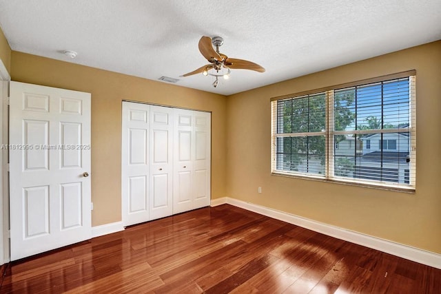 2434 SW 157th Ave, Miramar, FL 33027 - unfurnished bedroom featuring baseboards, dark wood-style flooring, a closet, a textured ceiling, and ceiling fan