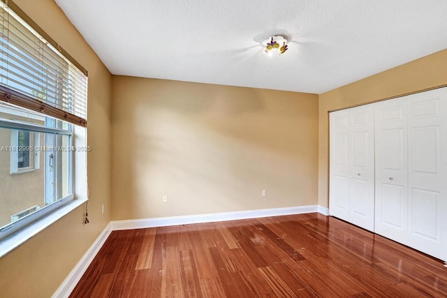 2434 SW 157th Ave, Miramar, FL 33027 - unfurnished bedroom featuring wood-type flooring, baseboards, and a closet