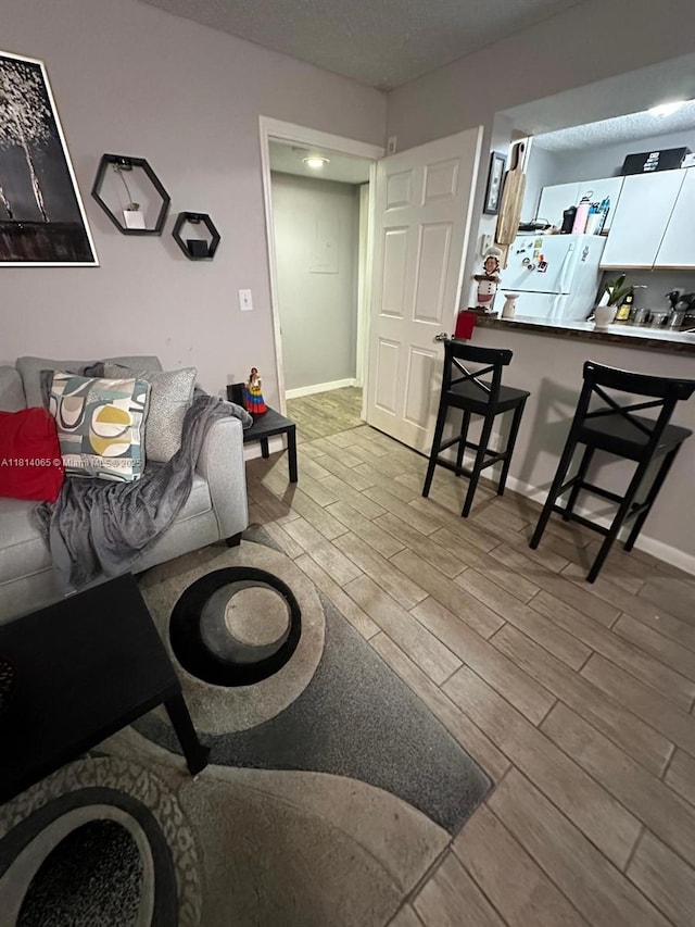 3995 W Mcnab Rd Unit B212, Pompano Beach, FL 33069 - living room featuring wood finished floors and baseboards
