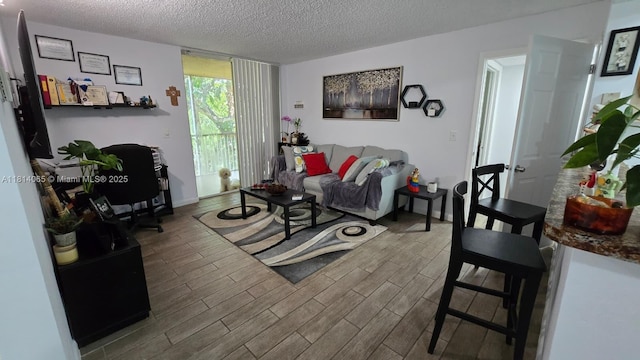 3995 W Mcnab Rd Unit B212, Pompano Beach, FL 33069 - living area featuring wood finished floors, a textured ceiling, and an office area