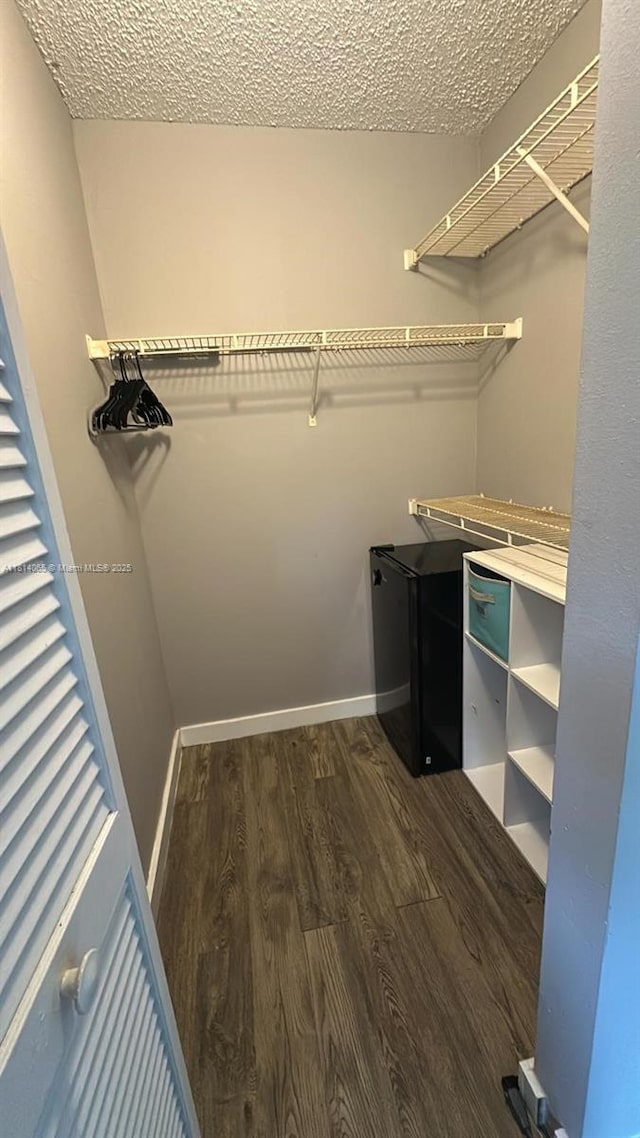3995 W Mcnab Rd Unit B212, Pompano Beach, FL 33069 - walk in closet featuring dark wood-type flooring