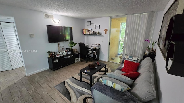 3995 W Mcnab Rd Unit B212, Pompano Beach, FL 33069 - living area with a textured ceiling, wood finished floors, and an office area