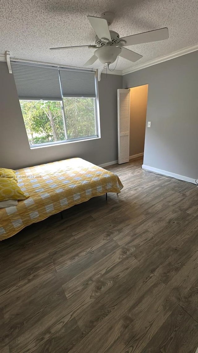 3995 W Mcnab Rd Unit B212, Pompano Beach, FL 33069 - bedroom with ornamental molding, a textured ceiling, dark wood-style floors, ceiling fan, and baseboards