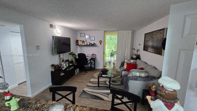 3995 W Mcnab Rd Unit B212, Pompano Beach, FL 33069 - tiled living area featuring a textured ceiling and a desk