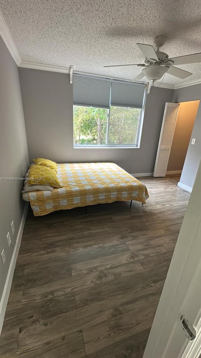 3995 W Mcnab Rd Unit B212, Pompano Beach, FL 33069 - bedroom featuring ornamental molding, a textured ceiling, baseboards, a ceiling fan, and wood finished floors