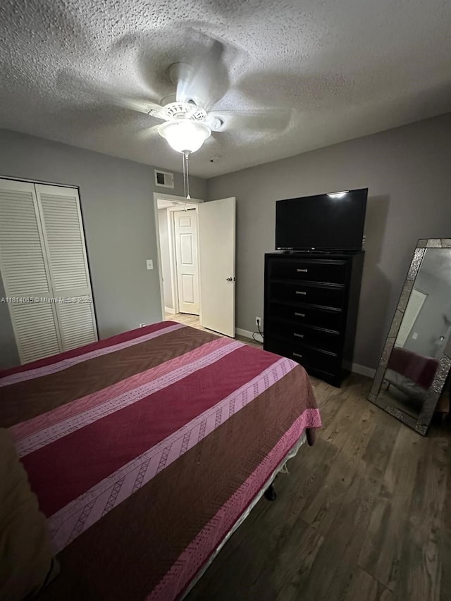 3995 W Mcnab Rd Unit B212, Pompano Beach, FL 33069 - bedroom with wood finished floors, ceiling fan, a closet, baseboards, and a textured ceiling