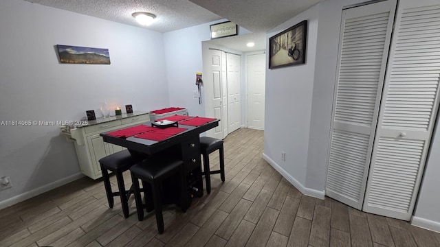 3995 W Mcnab Rd Unit B212, Pompano Beach, FL 33069 - dining room featuring wood finished floors and a textured ceiling