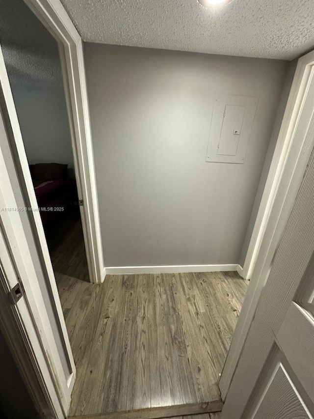 3995 W Mcnab Rd Unit B212, Pompano Beach, FL 33069 - interior space featuring wood finished floors, baseboards, a textured ceiling, and electric panel