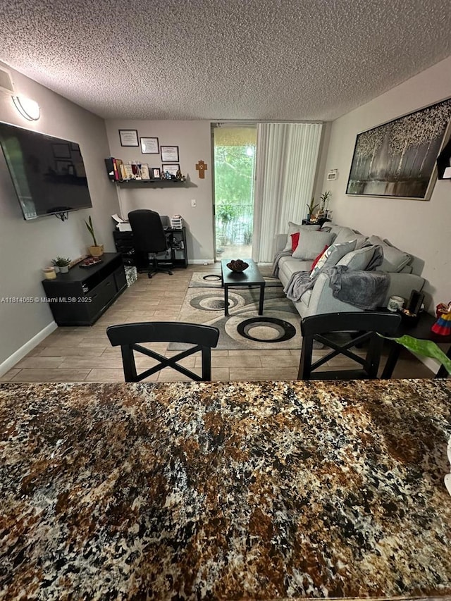 3995 W Mcnab Rd Unit B212, Pompano Beach, FL 33069 - living room featuring a textured ceiling and an office area