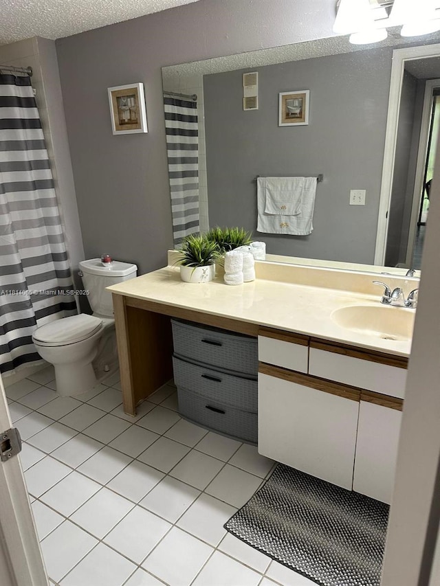 3995 W Mcnab Rd Unit B212, Pompano Beach, FL 33069 - full bathroom featuring toilet, vanity, tile patterned floors, and a textured ceiling