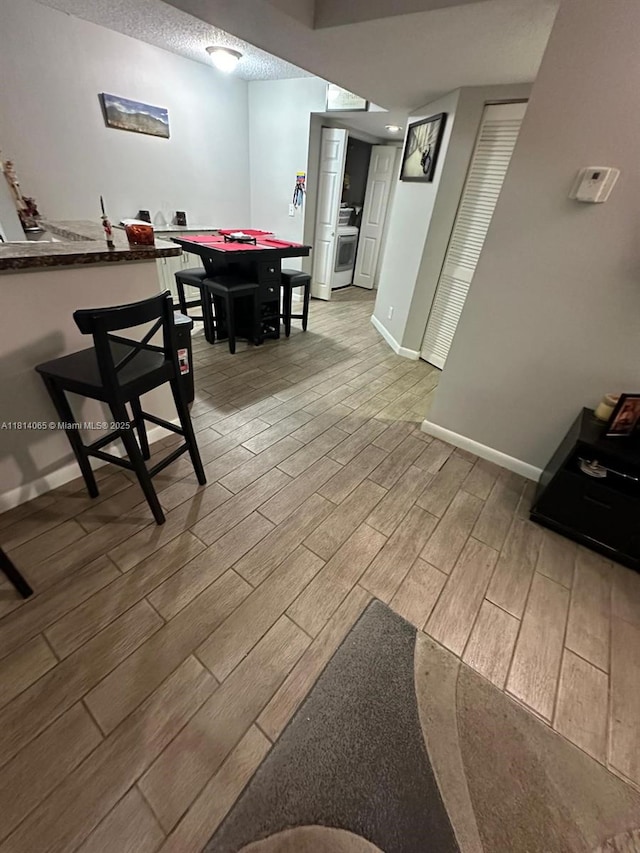 3995 W Mcnab Rd Unit B212, Pompano Beach, FL 33069 - game room featuring light wood finished floors, baseboards, and a textured ceiling