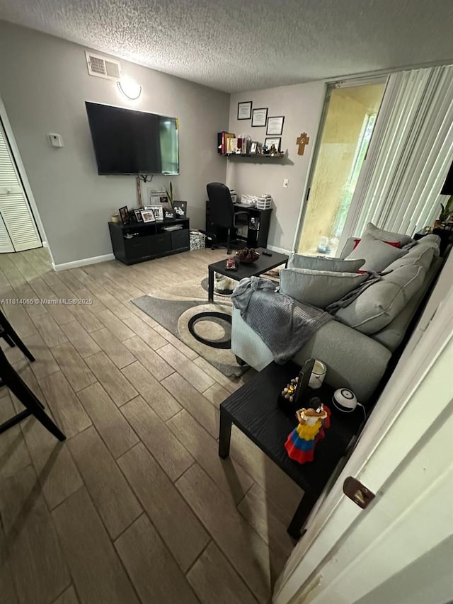 3995 W Mcnab Rd Unit B212, Pompano Beach, FL 33069 - living room with wood finished floors, an office area, and a textured ceiling