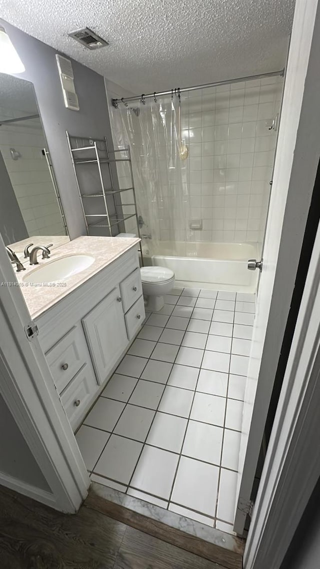 3995 W Mcnab Rd Unit B212, Pompano Beach, FL 33069 - full bathroom with a textured ceiling, vanity, shower / bath combo, toilet, and tile patterned floors