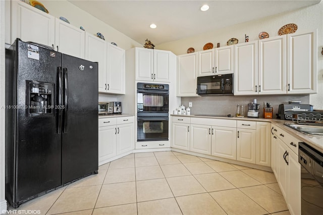 kitchen with black appliances, light tile patterned flooring, white cabinetry, recessed lighting, and a sink