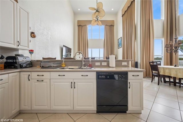 kitchen with dishwasher, a sink, white cabinetry, light tile patterned floors, and light countertops