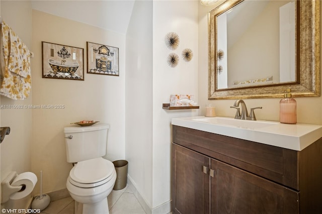bathroom featuring baseboards, vanity, toilet, and tile patterned flooring