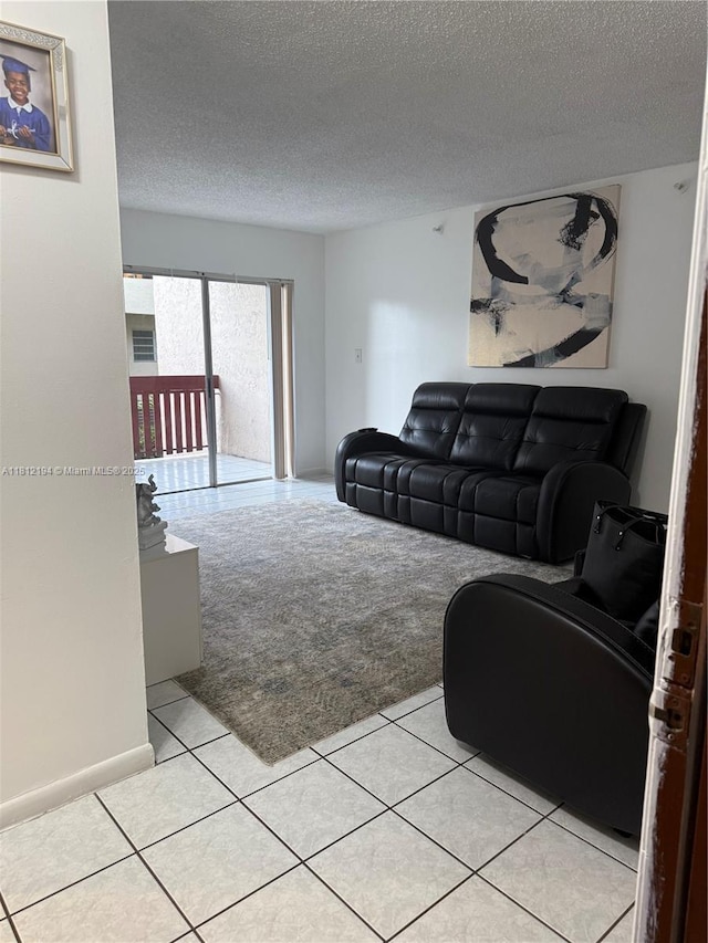 10661 SW 108th Ave Unit 2E, Miami, FL 33176 - living area with light carpet, a textured ceiling, and light tile patterned floors