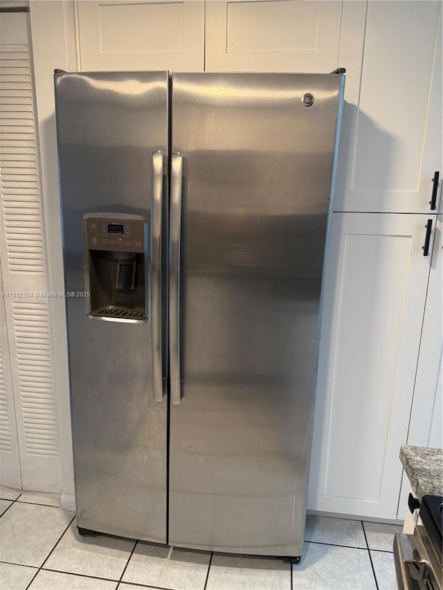 10661 SW 108th Ave Unit 2E, Miami, FL 33176 - kitchen view of stainless steel refrigerator with ice dispenser, dark stone countertops, and white cabinetry