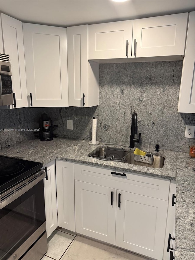10661 SW 108th Ave Unit 2E, Miami, FL 33176 - kitchen featuring a sink, stainless steel appliances, backsplash, and white cabinets
