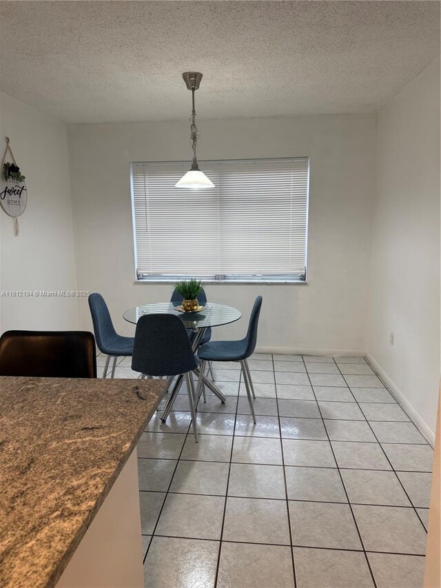 10661 SW 108th Ave Unit 2E, Miami, FL 33176 - dining area with a textured ceiling, baseboards, and light tile patterned flooring