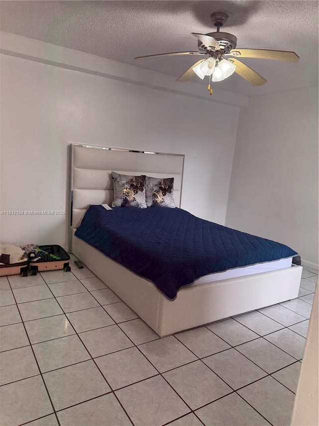 10661 SW 108th Ave Unit 2E, Miami, FL 33176 - bedroom with a textured ceiling, light tile patterned floors, and ceiling fan