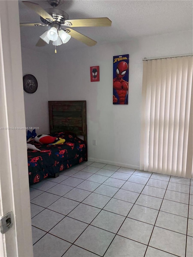 10661 SW 108th Ave Unit 2E, Miami, FL 33176 - bedroom with light tile patterned flooring, a textured ceiling, and ceiling fan