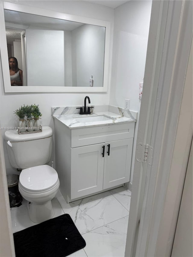 10661 SW 108th Ave Unit 2E, Miami, FL 33176 - half bathroom with vanity, toilet, and marble finish floors