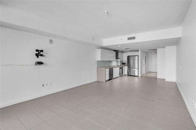 1600 NE 1st Ave Unit 1402, Miami, FL 33132 - unfurnished living room featuring a sink, light tile patterned flooring, and baseboards