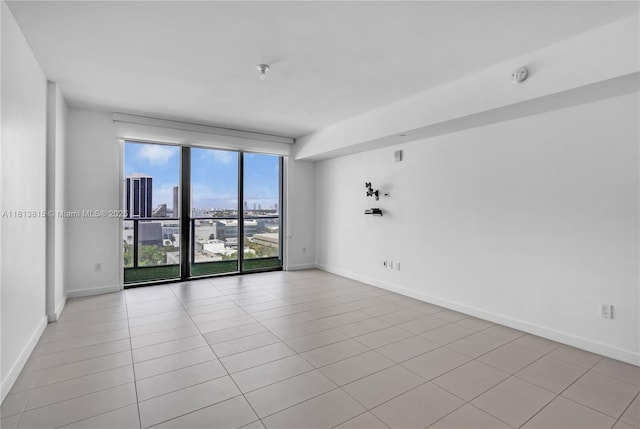 1600 NE 1st Ave Unit 1402, Miami, FL 33132 - empty room with baseboards, a view of city, tile patterned floors, and a smoke detector