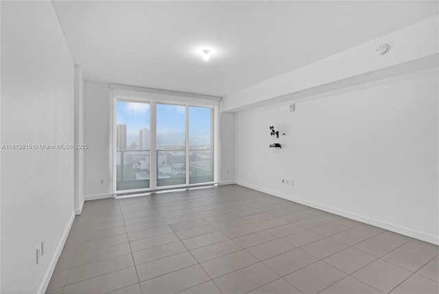 1600 NE 1st Ave Unit 1402, Miami, FL 33132 - empty room featuring tile patterned floors, baseboards, and a smoke detector
