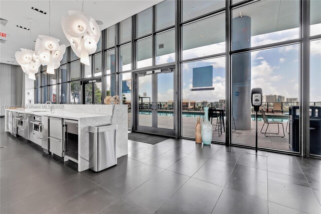 1600 NE 1st Ave Unit 1402, Miami, FL 33132 - building lobby featuring a wall of windows, a towering ceiling, and a sink