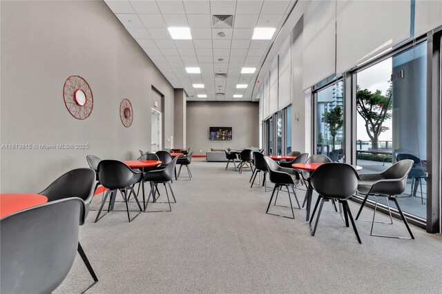 1600 NE 1st Ave Unit 1402, Miami, FL 33132 - dining space with light colored carpet, a drop ceiling, and a towering ceiling