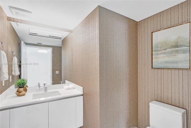 330 Sunny Isles Blvd Unit 5-1808, Sunny Isles Beach, FL 33160 - half bathroom featuring wallpapered walls, toilet, vanity, and a wall mounted air conditioner