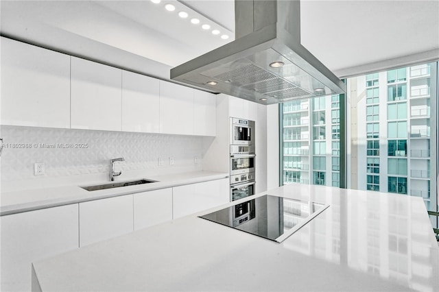 330 Sunny Isles Blvd Unit 5-1808, Sunny Isles Beach, FL 33160 - kitchen featuring black electric stovetop, a sink, island exhaust hood, and modern cabinets