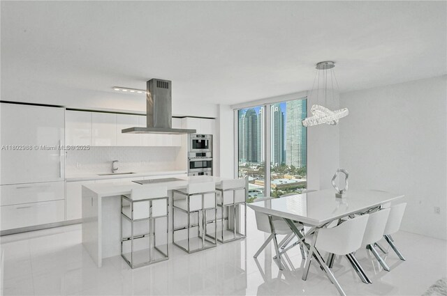 330 Sunny Isles Blvd Unit 5-1808, Sunny Isles Beach, FL 33160 - dining room featuring a chandelier and light tile patterned flooring
