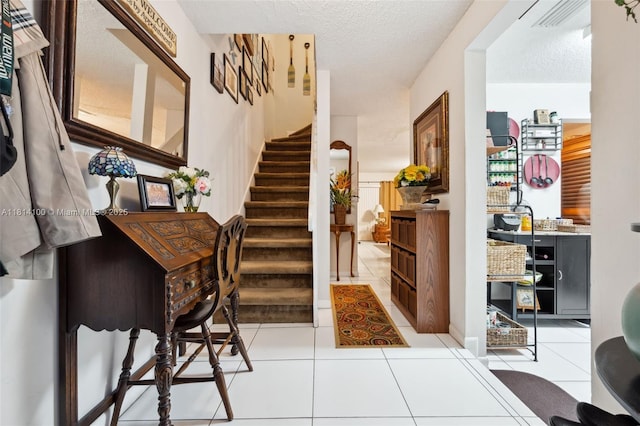 4119 NE 21st Ter, Lighthouse Point, FL 33064 - tiled foyer with stairs and a textured ceiling